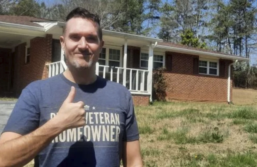 picture of Troy S. in front of a house